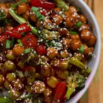 bowl of Mongolian chickpeas with sesame seeds on a wooden table