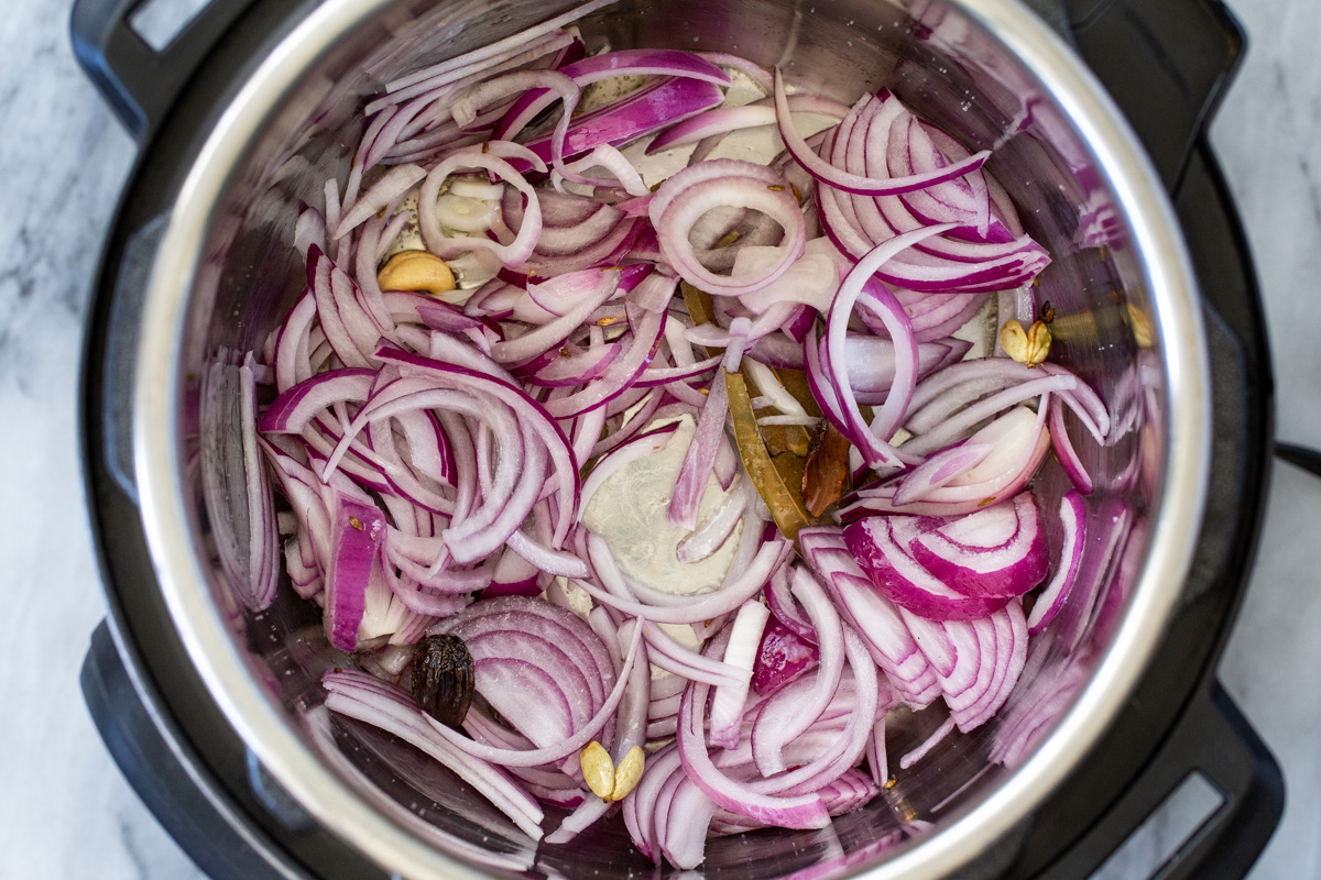 onions and spices in an Instant Pot 