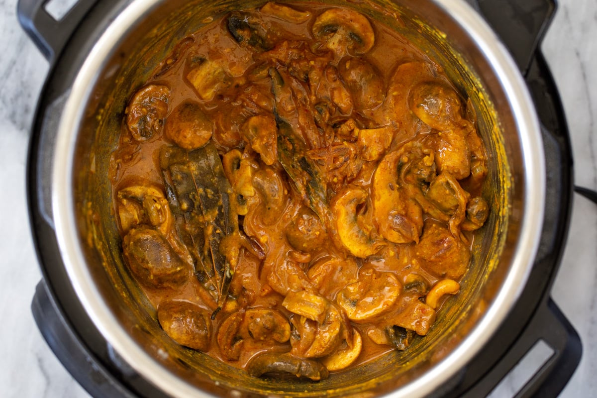 mushrooms cooking with Indian gravy in an Instant Pot 