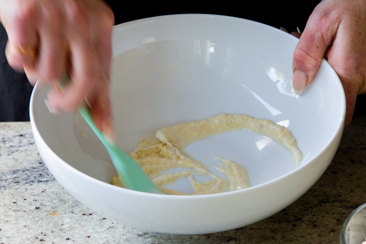mixing ginger-garlic paste and yogurt in a bowl