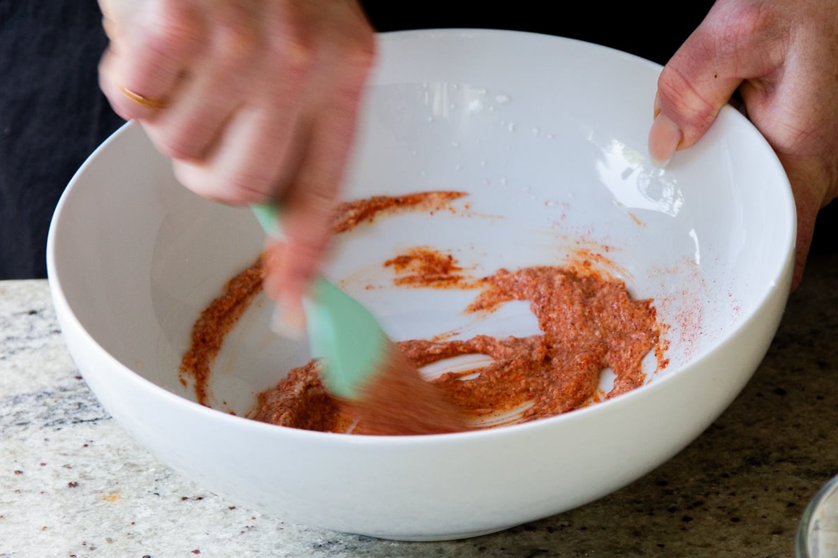 mixing Kashmiri chili powder into the yogurt mixture