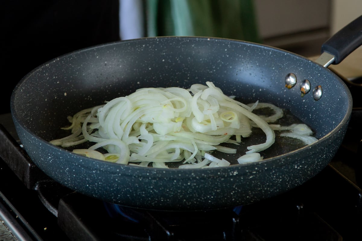 adding onion and salt to the pan