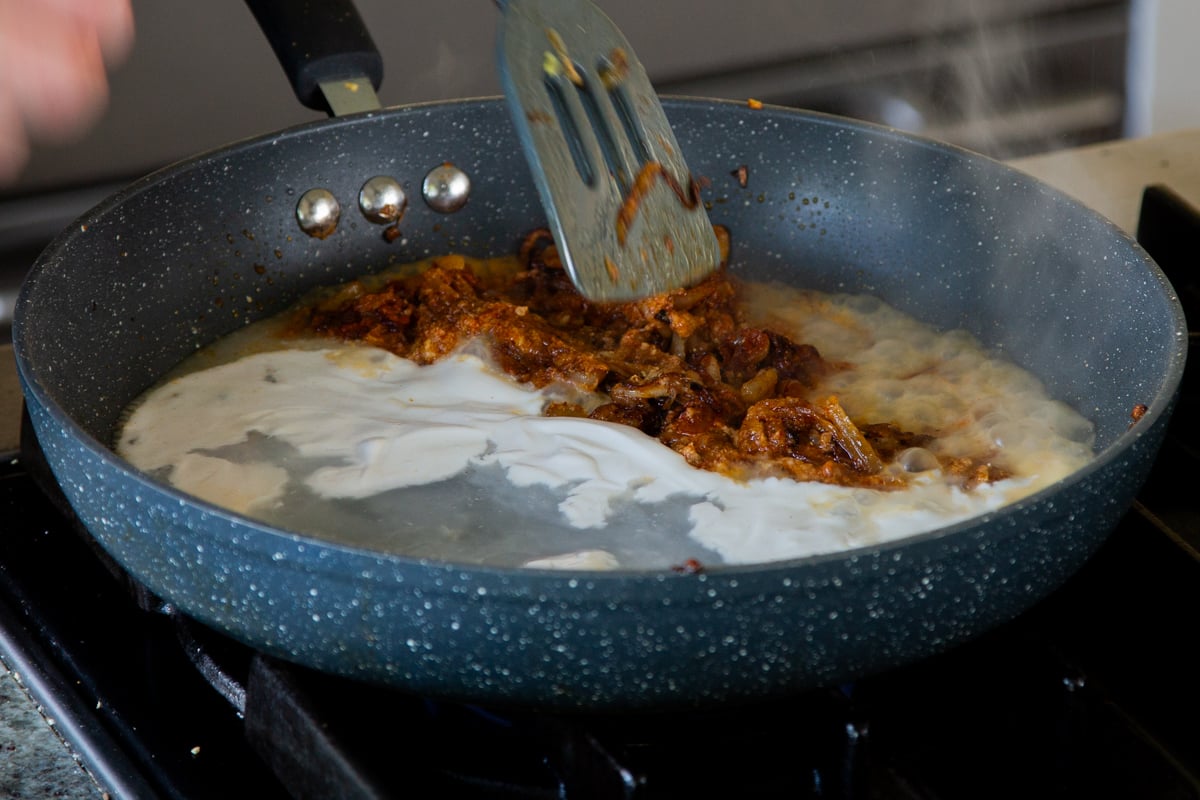 adding non-dairy yogurt to the onion mixture