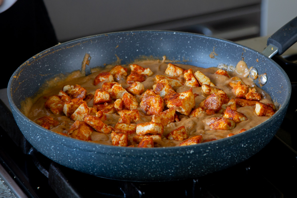 adding crispy tofu "mutton" back to the pan of Pahadi curry sauce