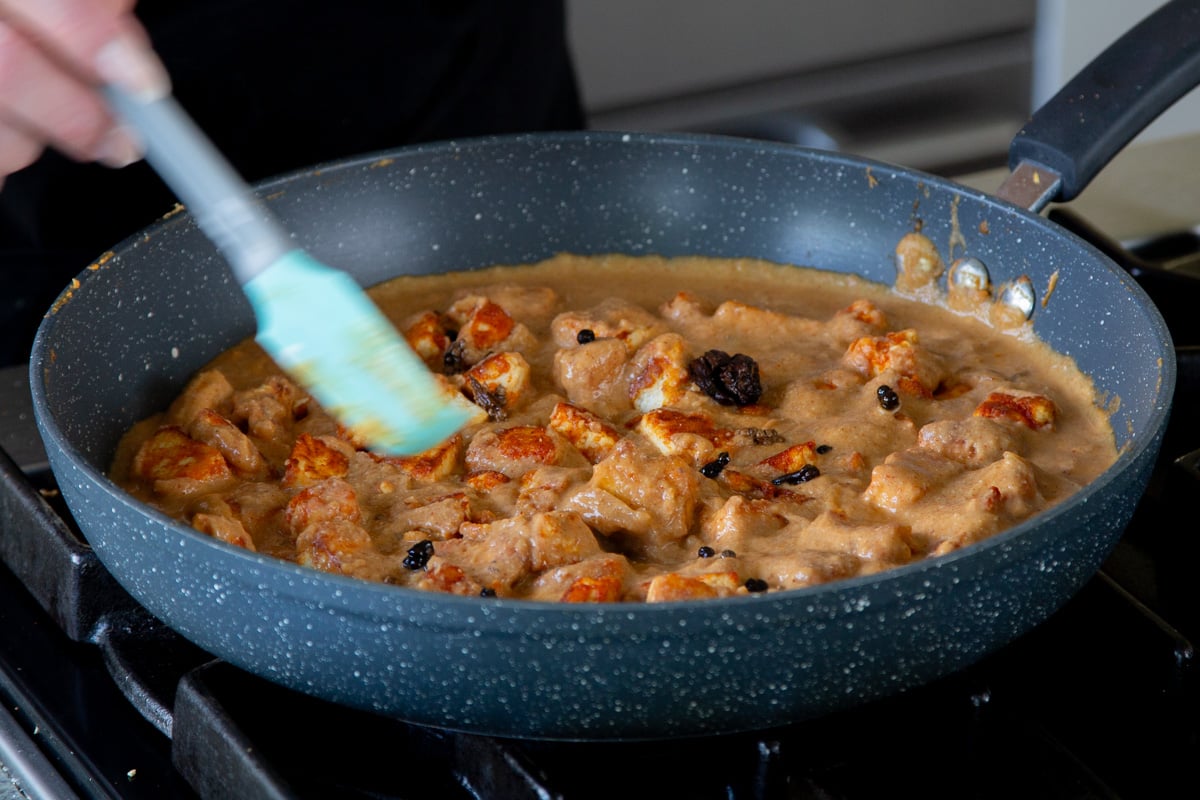 mixing crispy tofu "mutton" back into the pan of Pahadi curry sauce