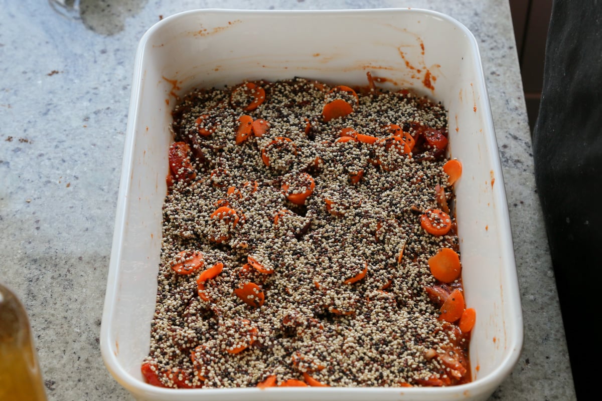 adding the quinoa to the pan