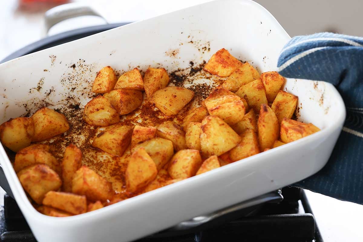 potatoes in the baking dish after baking with the spice coating