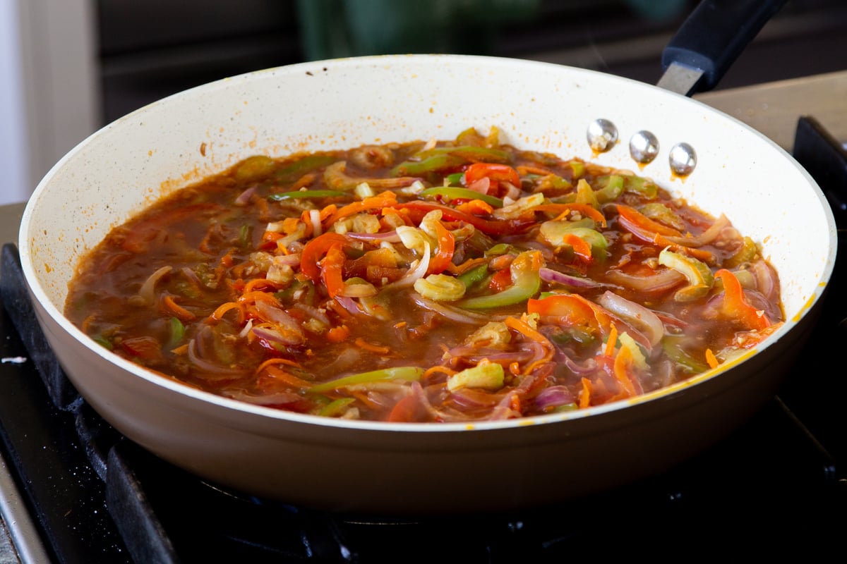 veggies mixed with the Szechuan sauce in the pan