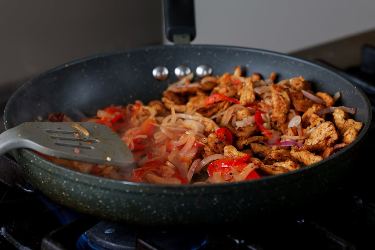 onions and peppers in the pan after cooking