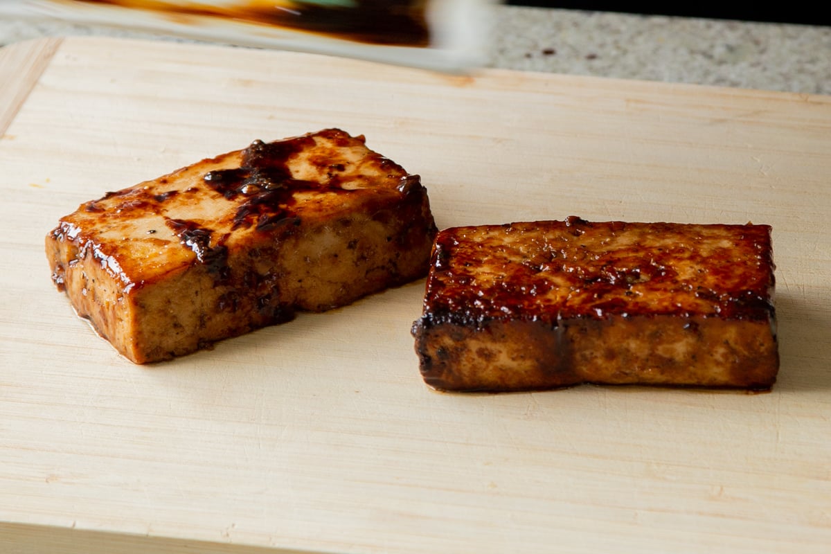 seared tofu on the cutting board before slicing
