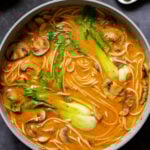 vegan tonkotsu in the pan next to the plate of seared tofu