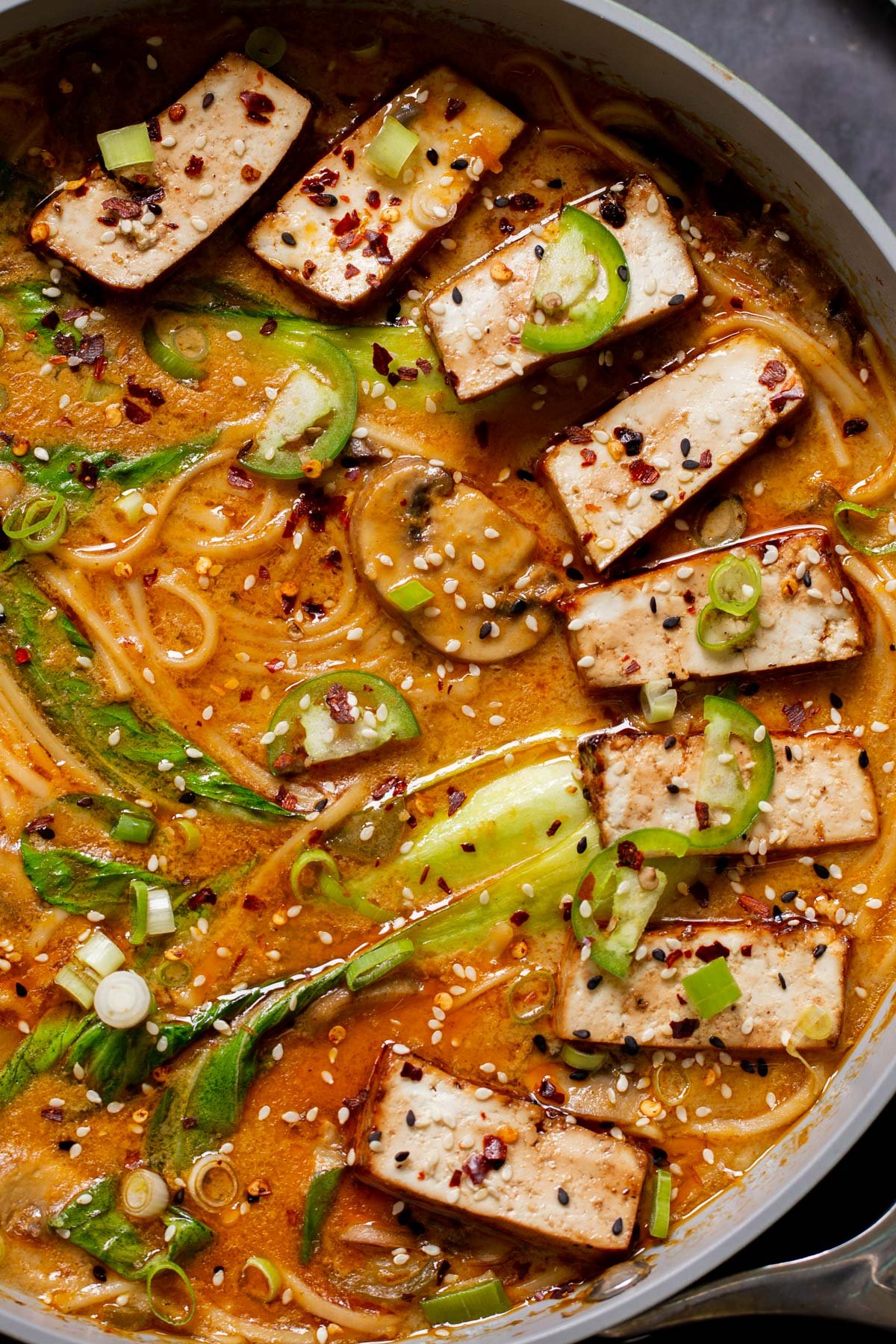 close-up of vegan tonkotsu in the pan after adding tofu and toppings