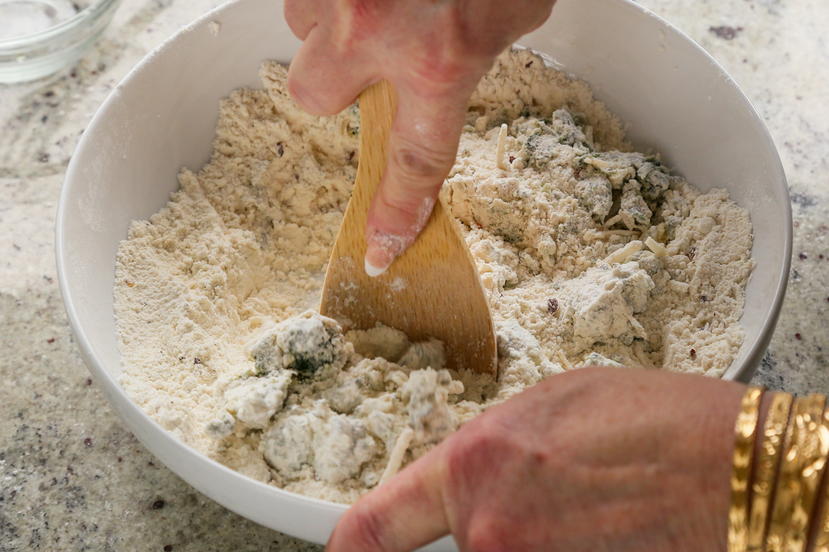 mixing the spinach and cheese into the scone dough