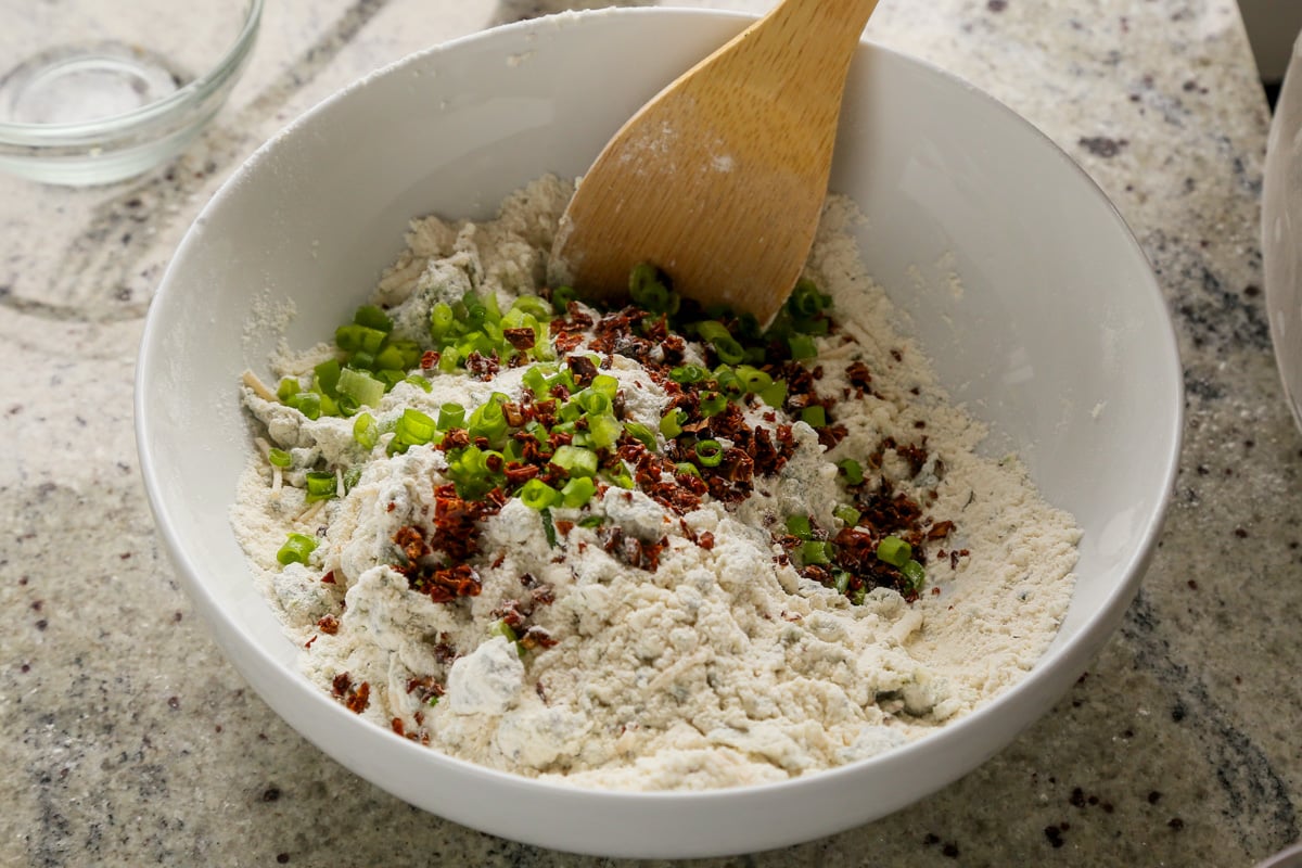 adding green onion and sun-dried tomato to the dry ingredients