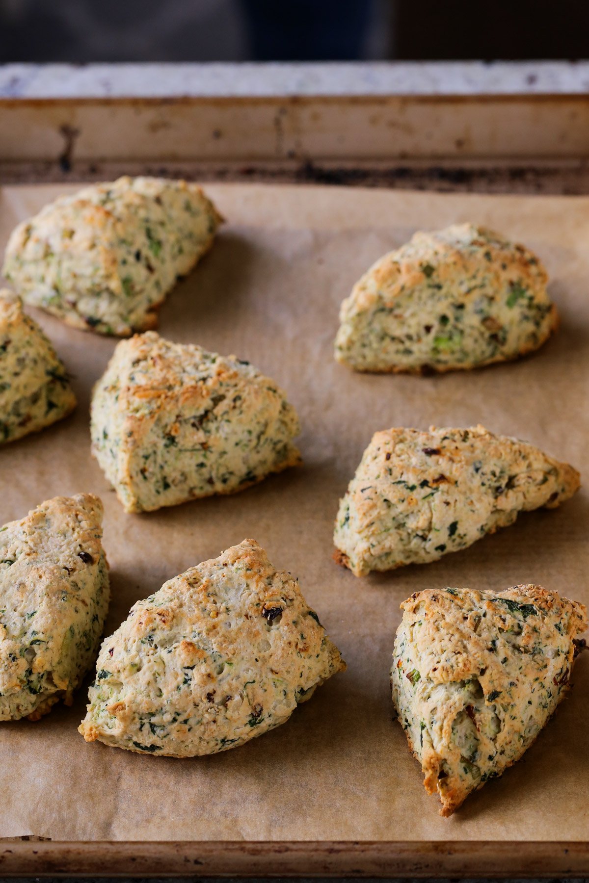 vegan spinach and cheese scones arranged on the baking sheet after baking
