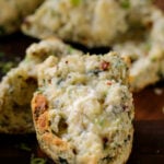 close-up of a vegan savory scone spread with butter