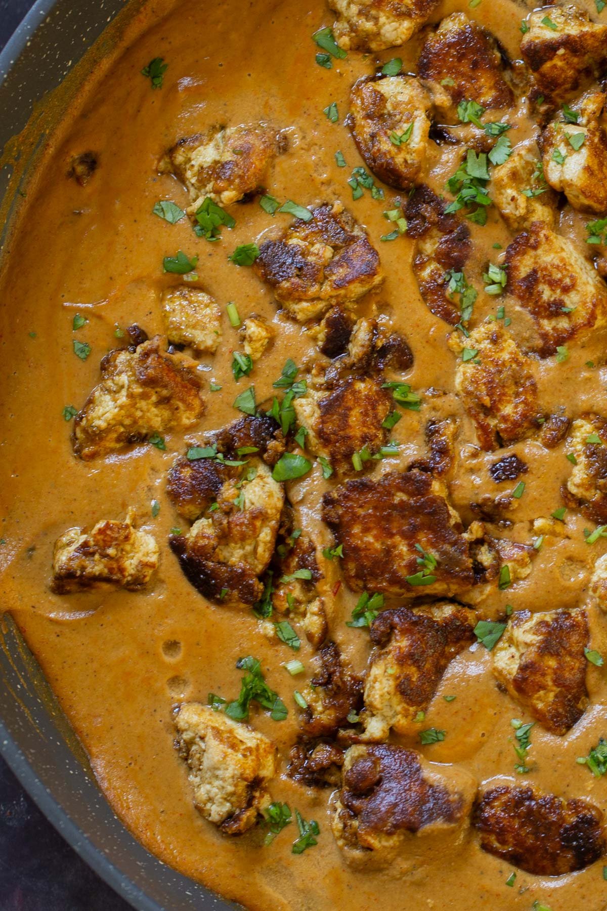 close-up of tofu barra in the pan after cooking and adding garnishes