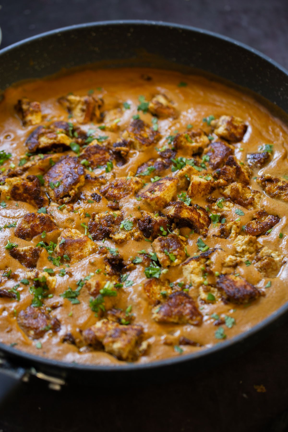 close-up of tofu barra in the pan after cooking and adding garnishes