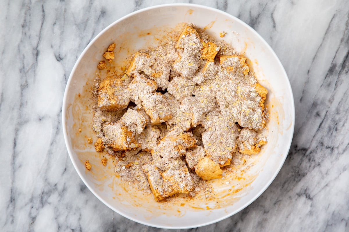 marinated tofu chunks in a white bowl 