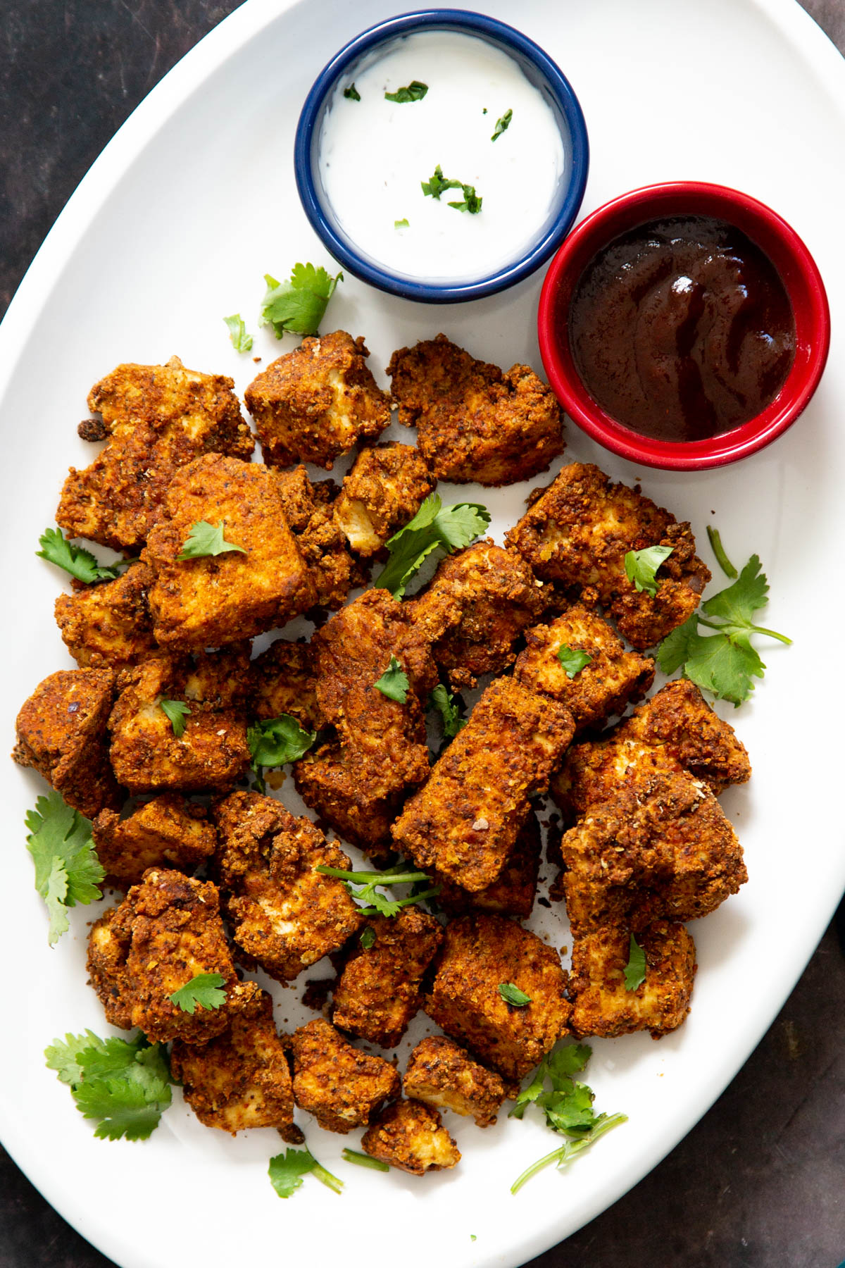 vegan baked tofu nuggets served with two different dips 