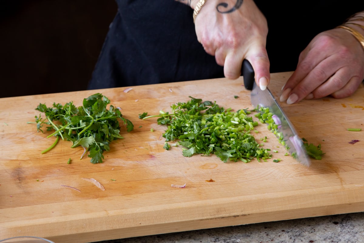 chopping cilantro and green chilis