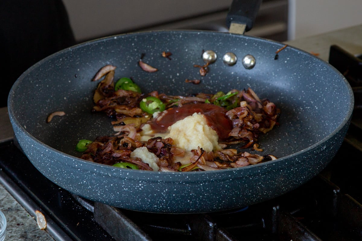 adding ketchup and ginger-garlic paste to the cooked onions