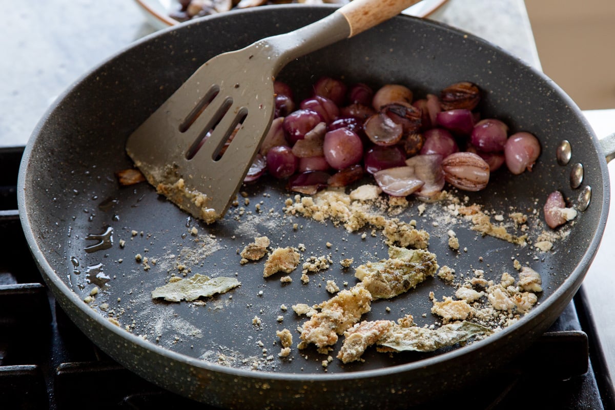 toasting the flour and herbs in the pan with the onions