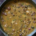 vegan mushroom gravy in the pan, after adding back the mushrooms and simmering