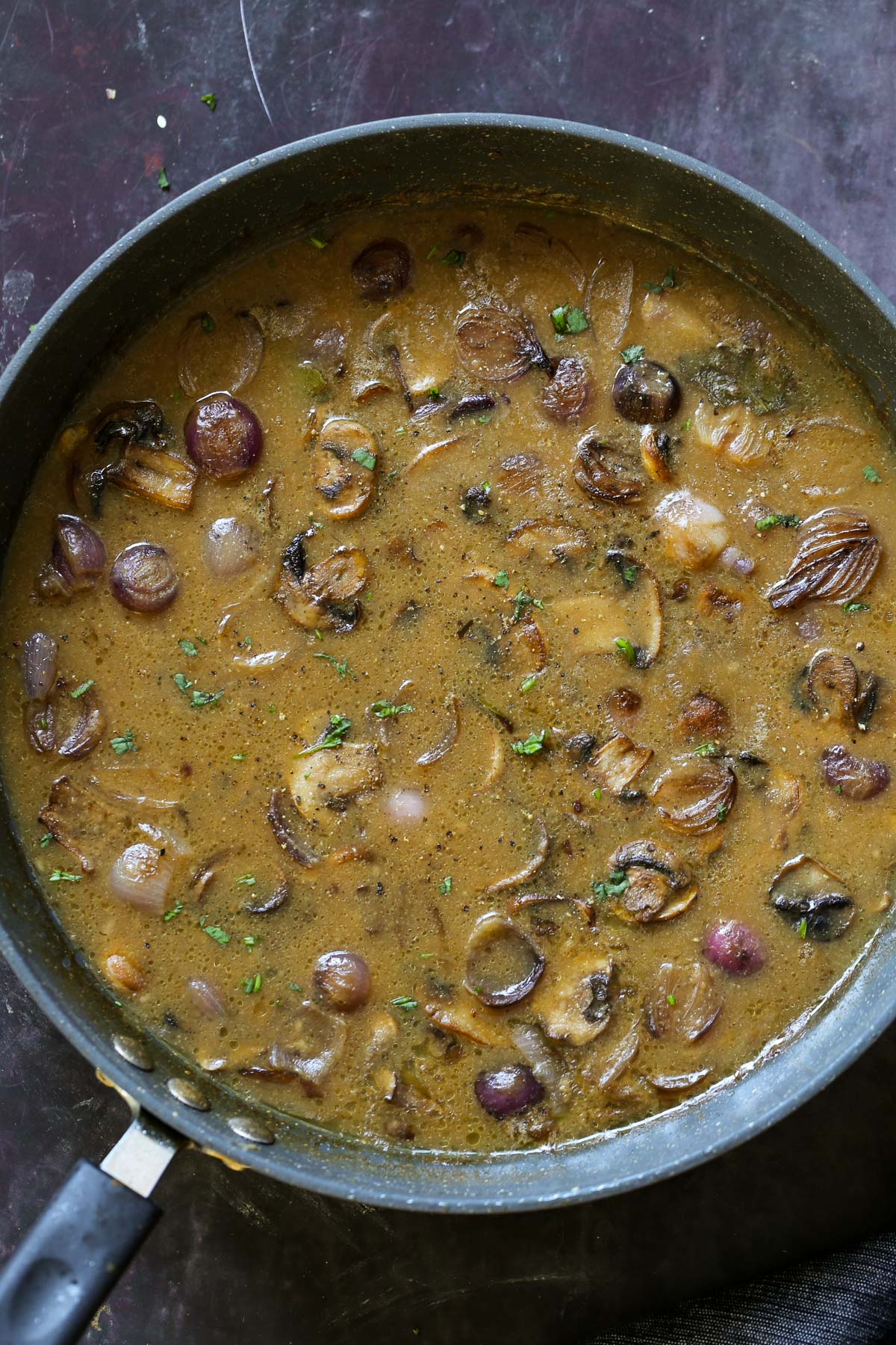 vegan mushroom gravy in the pan, after adding back the mushrooms and simmering