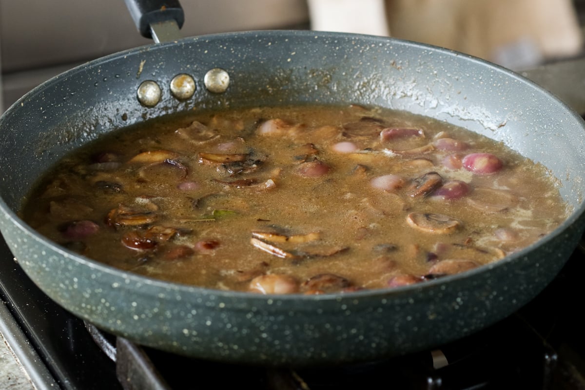 vegan mushroom gravy in the pan, after adding back the mushrooms and simmering