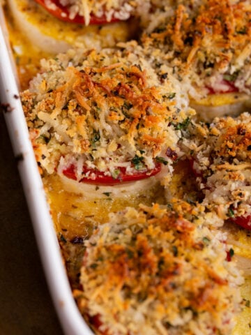 close-up of baked vegan caprese stacks in the baking dish, after baking
