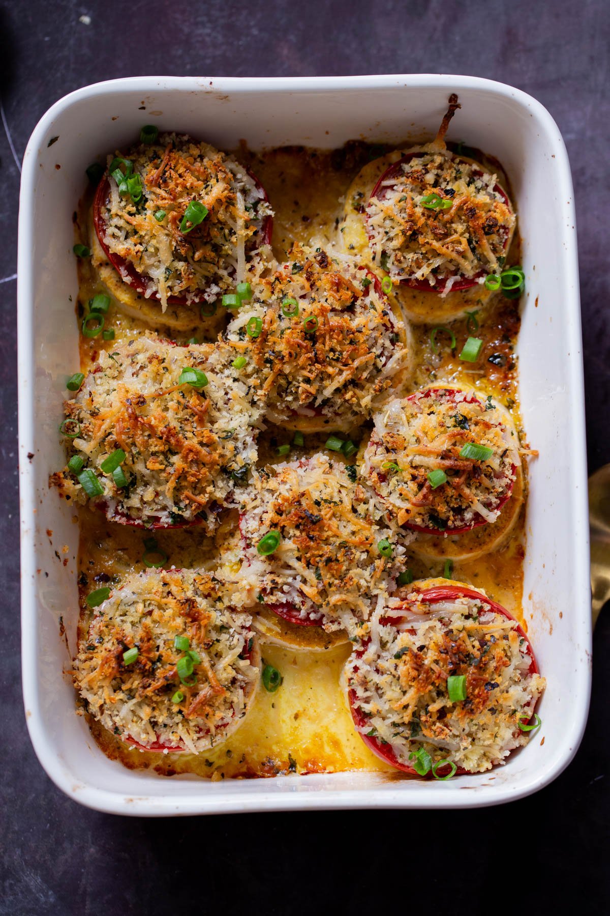 baked vegan caprese stacks in the baking dish, after baking