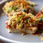 baked vegan caprese stacks on a plate with a bite taken out