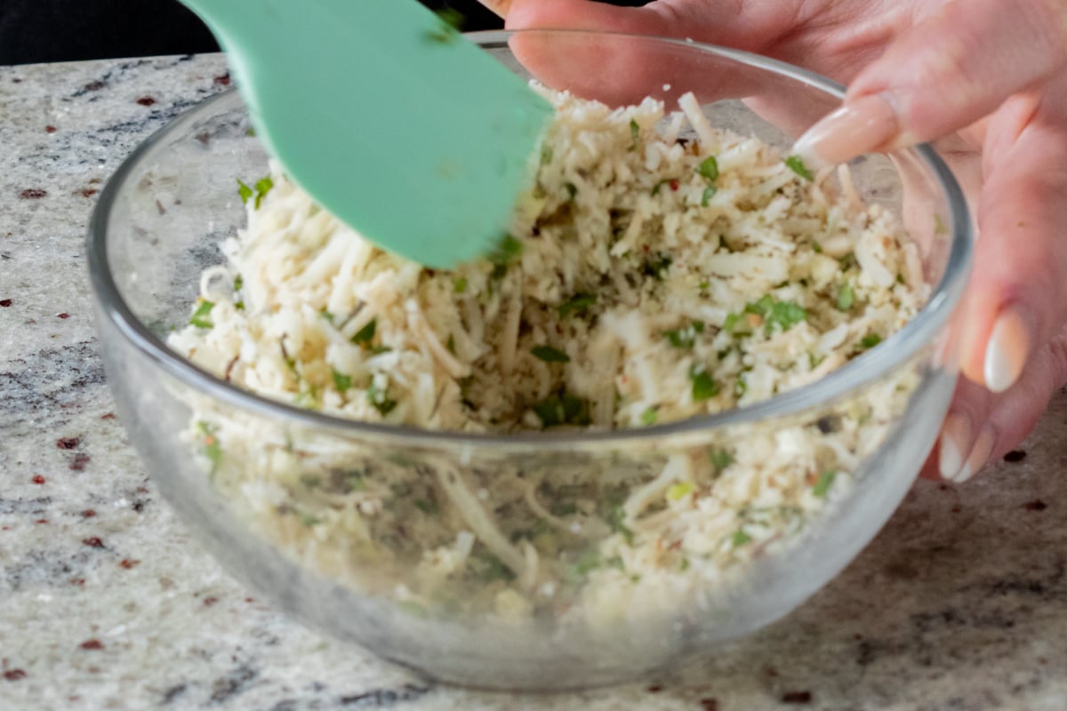 mixing breadcrumbs and seasonings into the vegan cheese shreds