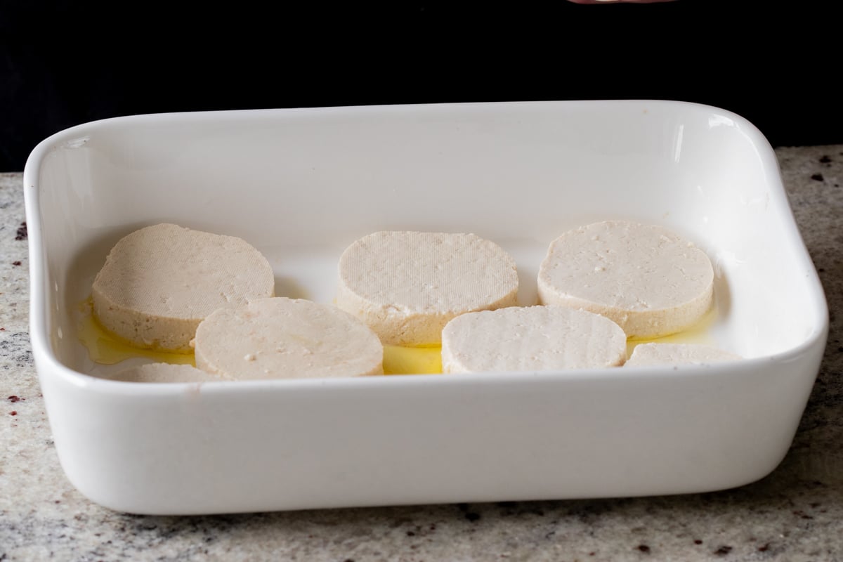 tofu rounds in the greased baking pan