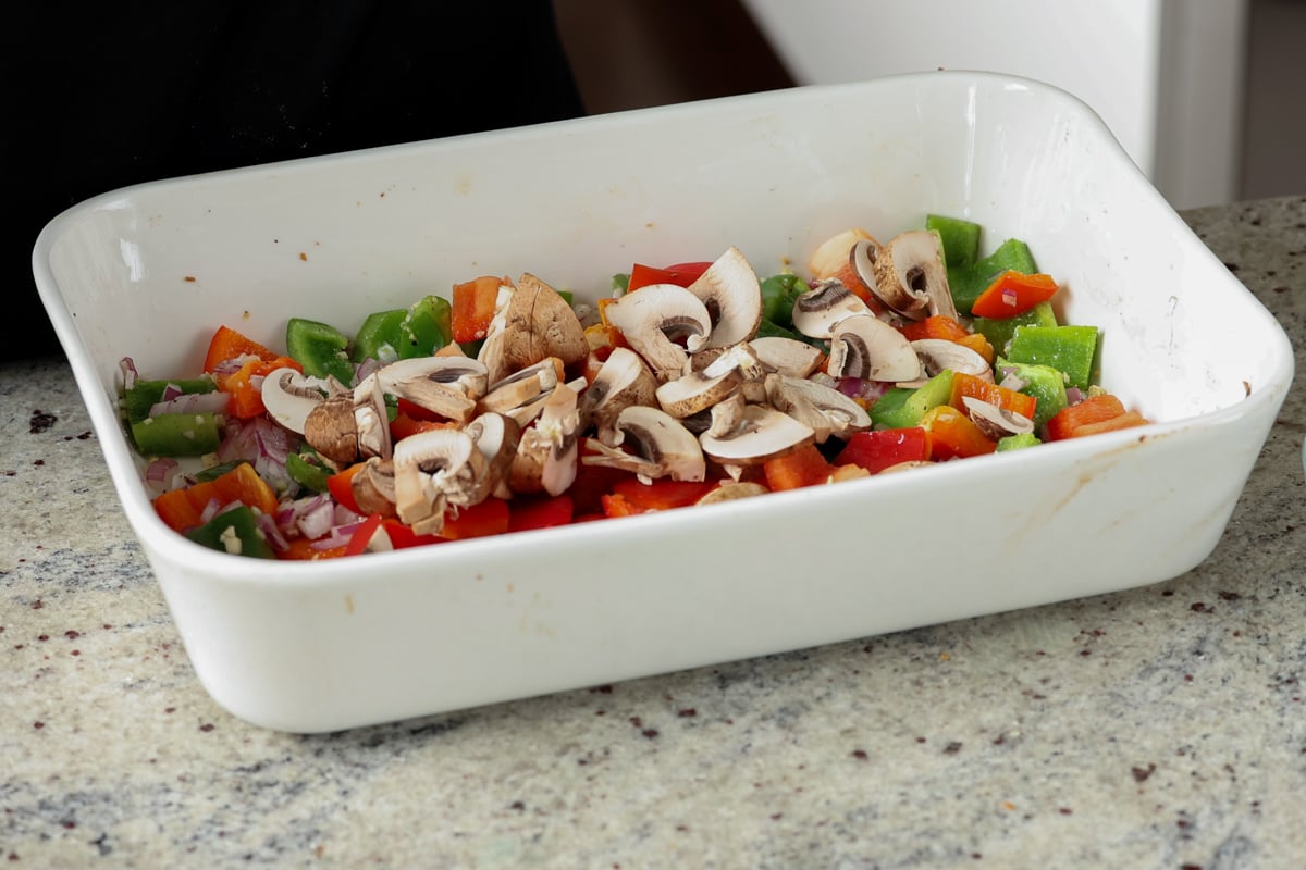 adding mushrooms to the veggie mixture