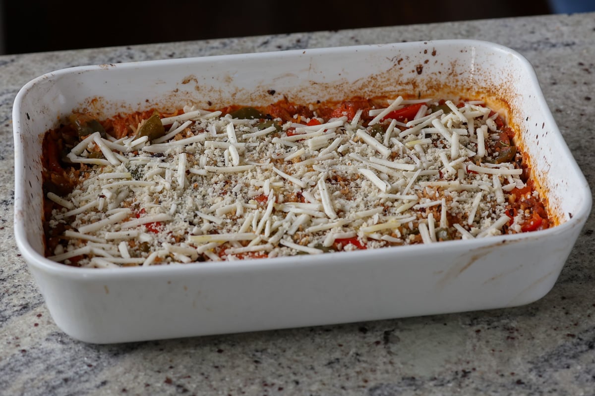 adding breadcrumb mixture on top of the casserole