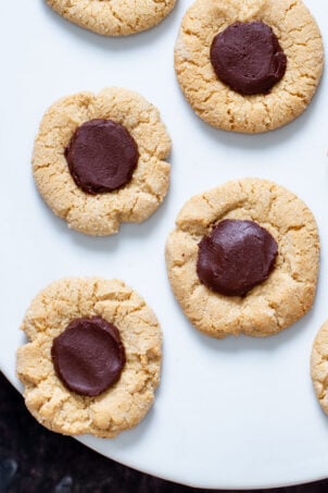 vegan glutenfree chocolate thumbprint cookies on a white plate