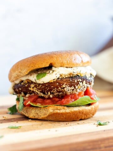 Vegan Portobello Mushroom Burger. Portobello marinated and stuffed with vegan mozzarella, then breaded to make Crispy Portobello Sandwiches! Top with more vegan mozzarella cream, fresh herbs. #Vegan #Recipe #VeganRicha #VeganPortobelloMushroomBurger #breadedportobello. Nutfree Gluten-free options