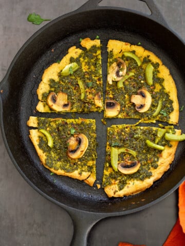 Socca Pizza with chimichurri and mushrooms on cast iron skillet