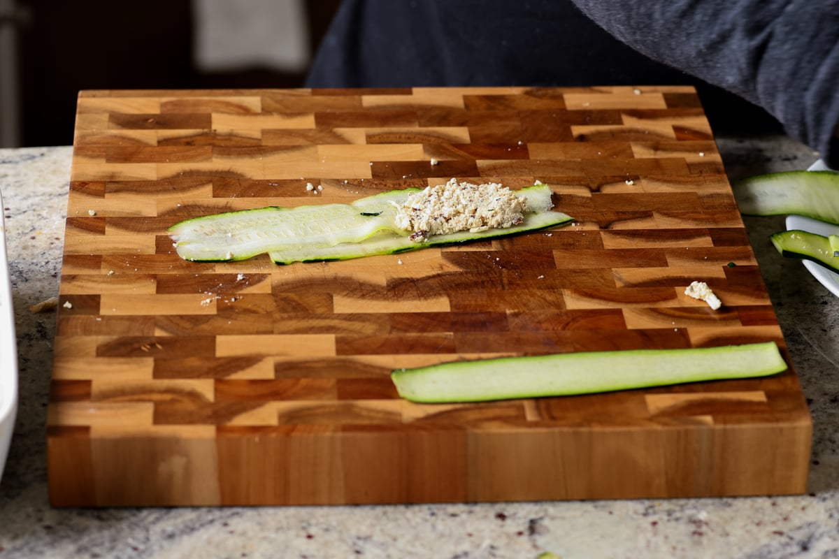 spreading filling onto the zucchini slices