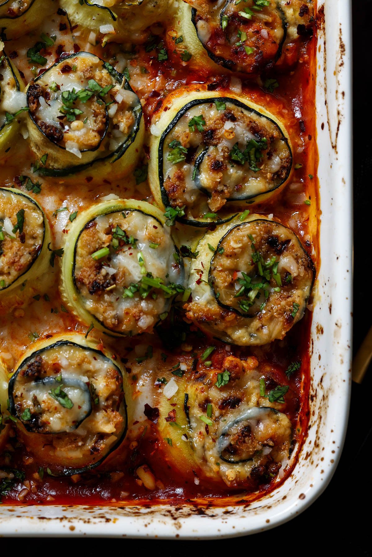 close-up of zucchini rolls in the baking dish after baking