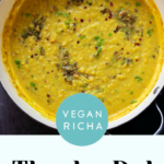 close-up of thecha dal in the skillet next to the mortar of thecha, text overlay